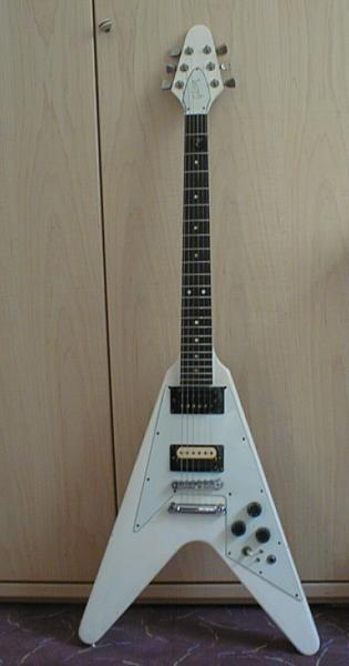 Gibson Flying V ´72

Tja, mit 15 war ich mal Schenker-Fan. Und wie Schenkers V hatte die hier auch mal einen Halsbruch. Und der Lack ist auch nicht mehr original. Der Originale Lack war rot. Der Pickup am Steg ist ein DiMarzio Super 3.